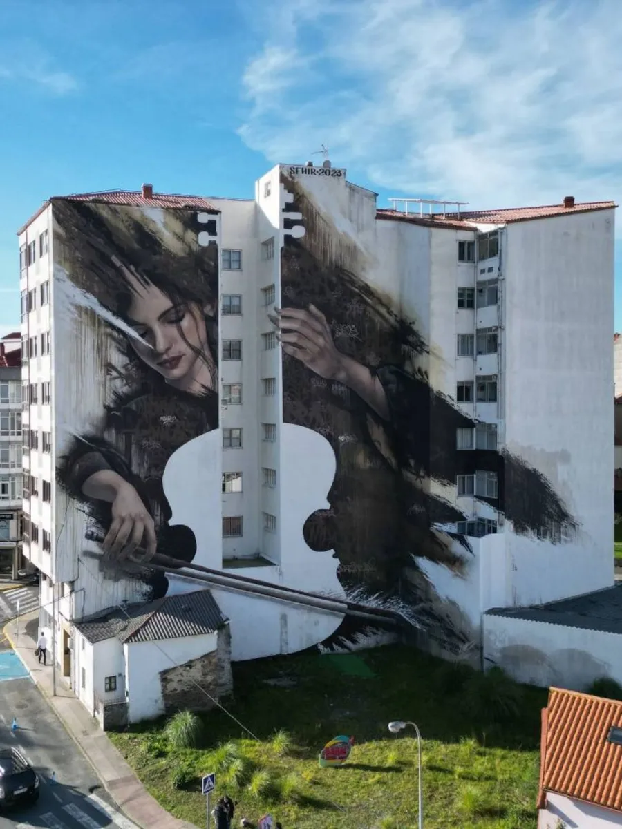 The Cellist mural by SFHIR in Fene, street art near the English Way